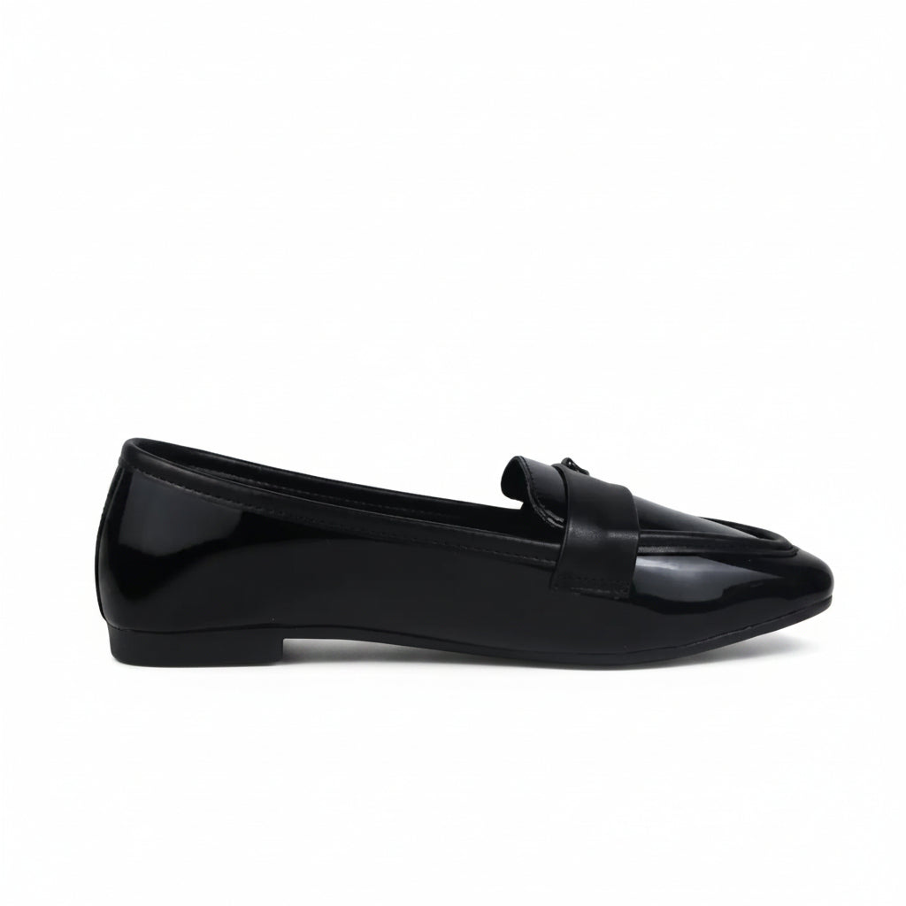 A single black patent leather loafer flat shown in profile against a light gray textured background.