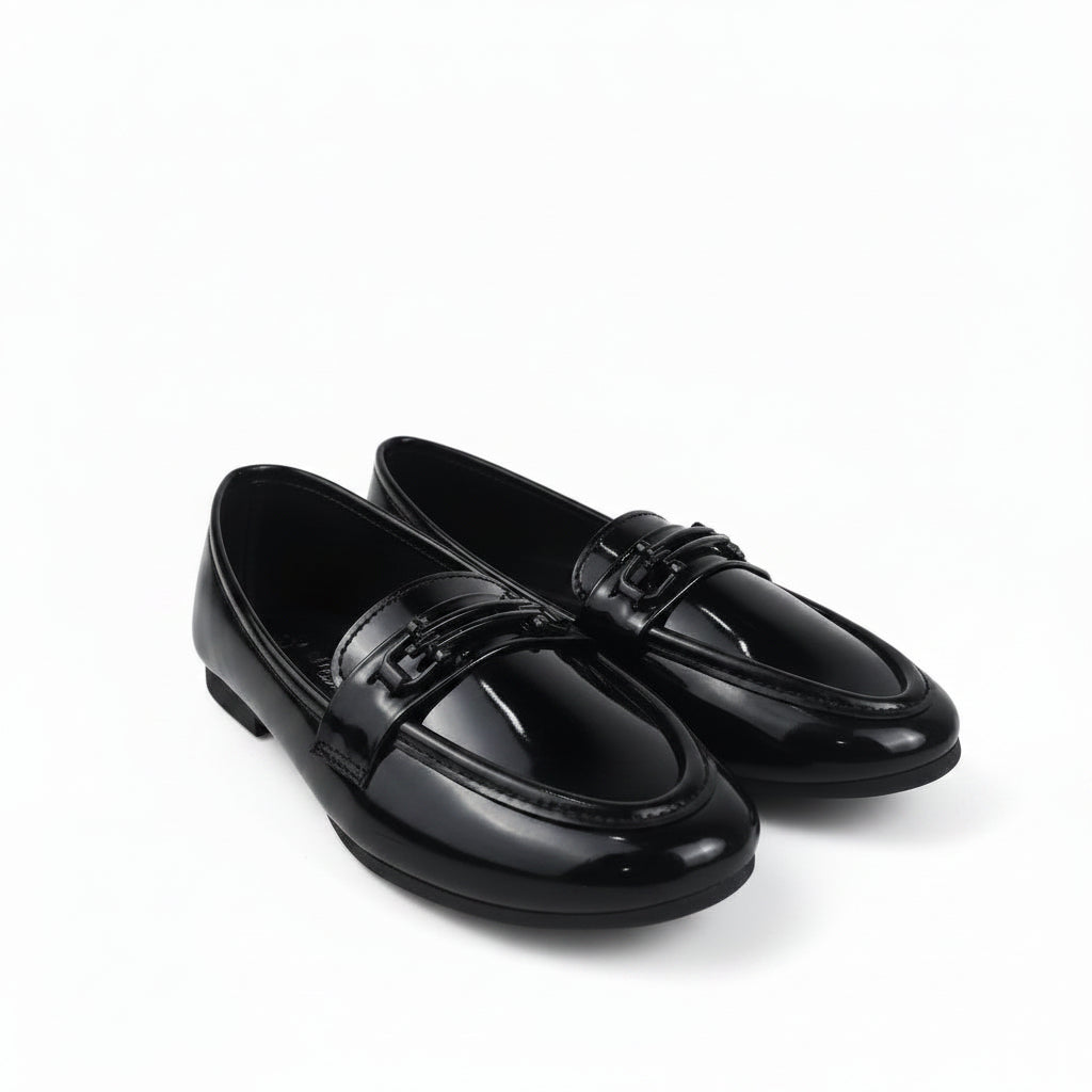 A pair of glossy black patent leather penny loafers with decorative straps across the vamp, displayed on a white studio background.
