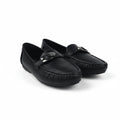 A pair of black leather driving loafers with a silver-tone horsebit detail on the strap, displayed on a white studio floor.