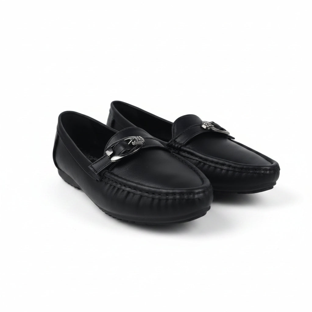 A pair of black leather driving loafers with a silver-tone horsebit detail on the strap, displayed on a white studio floor.