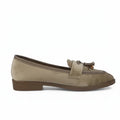 A beige suede loafer with a brown tassel detail on the strap, shown in a side profile against a light gray background.