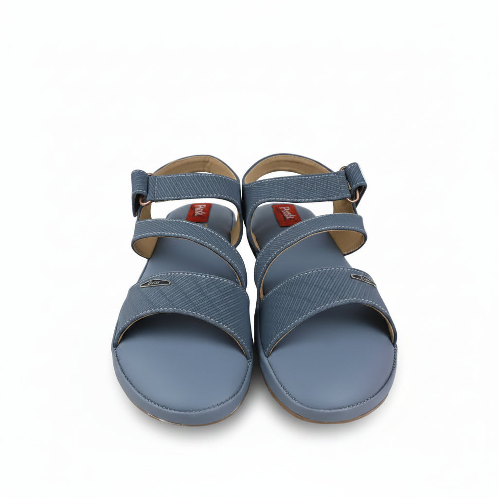 A pair of Metylan blue woven sandals with adjustable straps, shown next to a red Metylan shoebox on a white background.