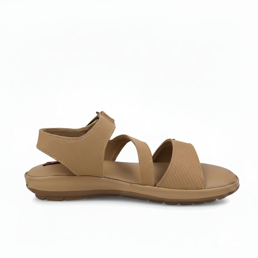A single tan woven-texture sandal with two adjustable straps and a low wedge heel, shown in profile against a light gray background.
