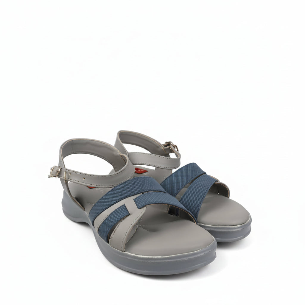 A pair of women's casual sandals with gray footbeds and straps, featuring textured blue woven detail and adjustable ankle straps, photographed on a white studio background.