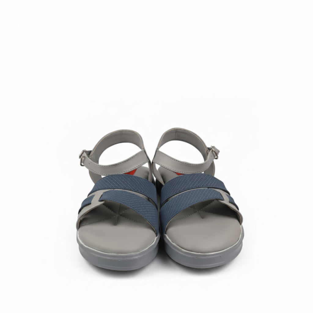 A pair of women's casual sandals with gray soles and straps, featuring textured blue straps across the foot, shown next to their red and black Posh's shoebox on a white background.