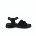 A single black platform sandal with an ankle strap and textured upper straps, shown in profile against a light gray background.