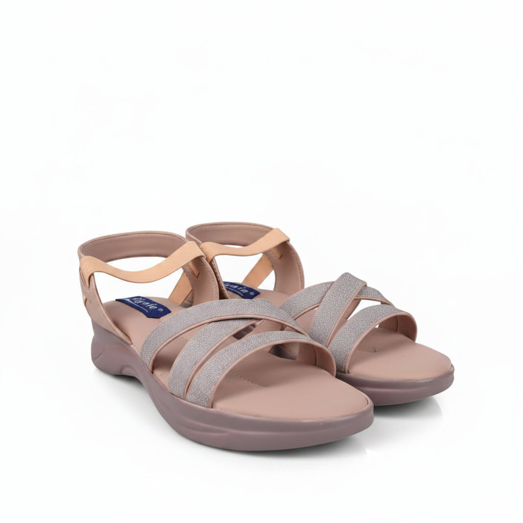 A pair of women's strappy sandals in a dusty pink and peach colorway, featuring glittery straps and a low wedge heel, photographed on a light gray studio background.