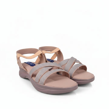 A pair of women's strappy sandals in a dusty pink and peach colorway, featuring glittery straps and a low wedge heel, photographed on a light gray studio background.