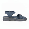 A single women's platform sandal in a muted slate blue color, featuring a thick gray sole and a small gold-tone decorative accent on the front strap, set against a light gray background.