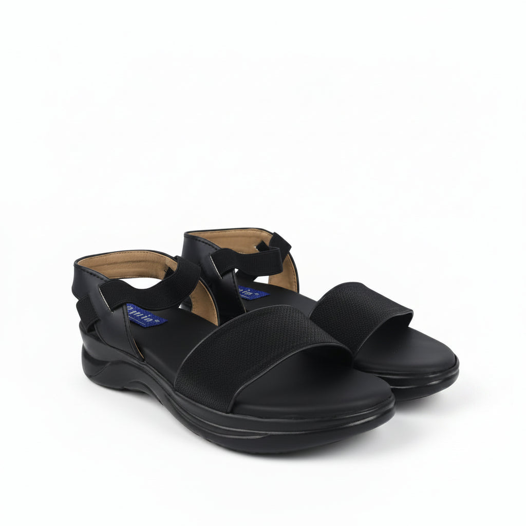 A pair of black open-toe comfort sandals with wide straps and adjustable ankle buckles, shown on a plain white background.