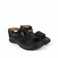 A pair of black open-toe comfort sandals with wide straps and adjustable ankle buckles, shown on a plain white background.