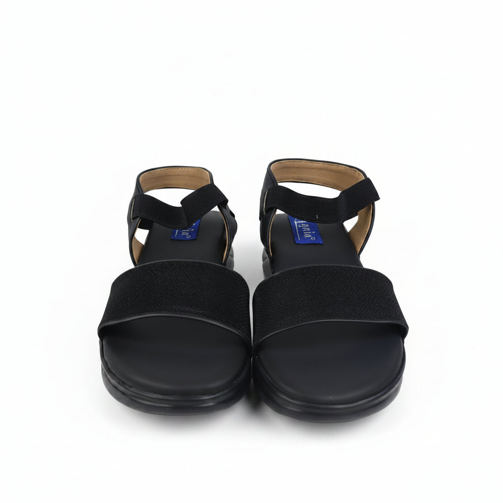 A pair of black slide sandals with wide straps and ankle bands, shown from the front on a white studio background.