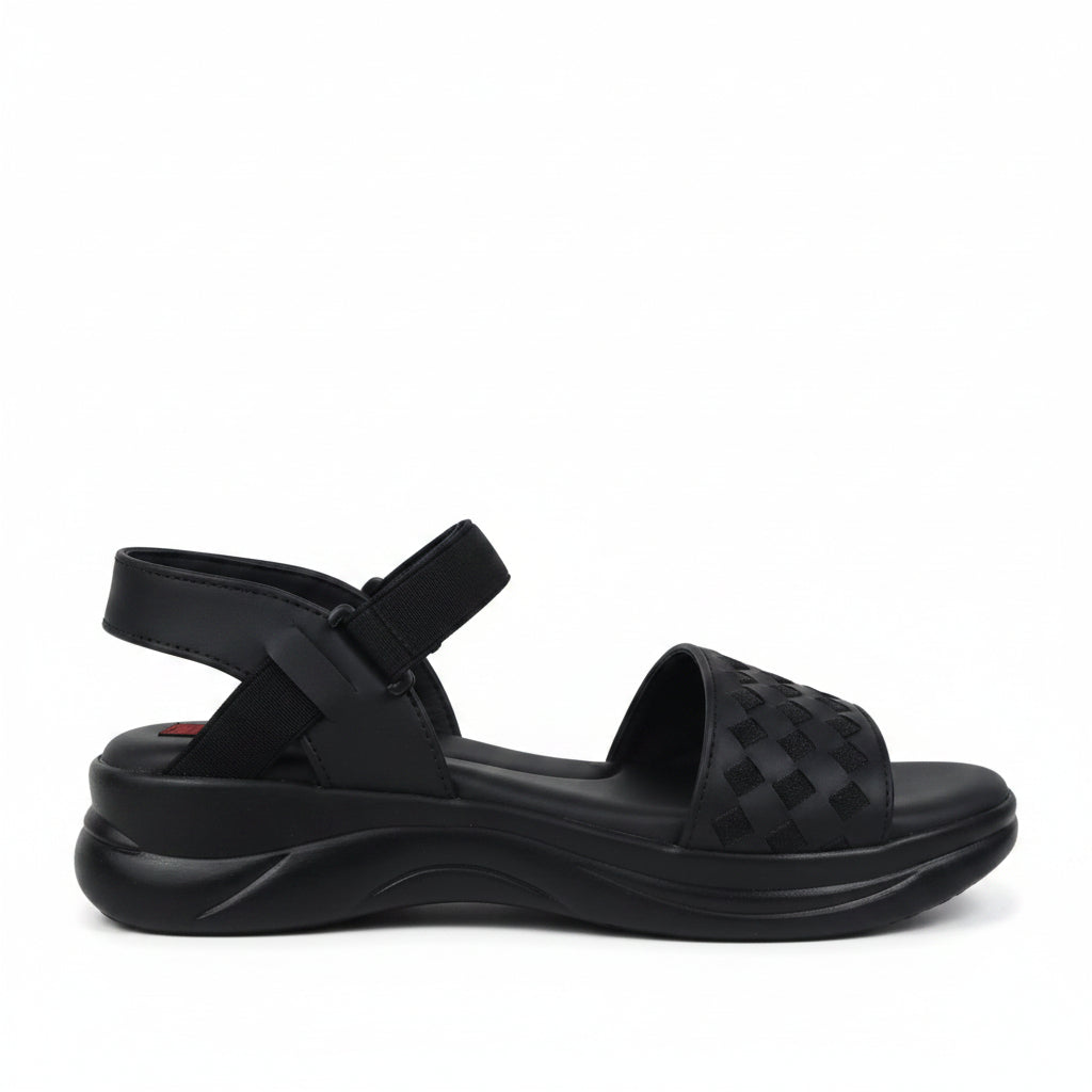 A pair of black woven-look slide sandals with adjustable ankle straps and bow details, photographed on a light gray studio background.
