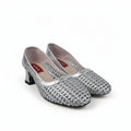 A pair of women's silver high-heeled pumps covered in rhinestones, displayed on a white studio background.