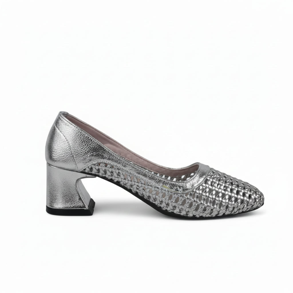 A single metallic silver pump shoe with a textured, woven pattern on the upper and a block heel, shown against a light gray fabric backdrop.