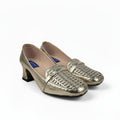 A pair of metallic gold women's loafers with a textured woven pattern across the toe, featuring a low block heel and black soles, set against a white studio backdrop.