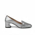 A single metallic silver pump shoe with a low block heel and a decorative rhinestone-embellished toe cap, shown against a light gray fabric backdrop.