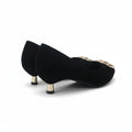 A pair of black velvet pointed-toe pumps with gold metallic heels and jeweled embellishments on the toe, set against a plain white background.