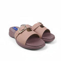 A pair of women's slide sandals in a dusty rose pink color, featuring double straps with gold-tone buckles and a low wedge heel, shown on a white studio background.