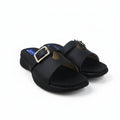 A pair of black slide sandals with a square buckle strap, displayed on a white fabric background.