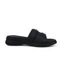 A single black slide sandal with a wide strap and a low wedge heel, shown from a side profile against a white studio background.