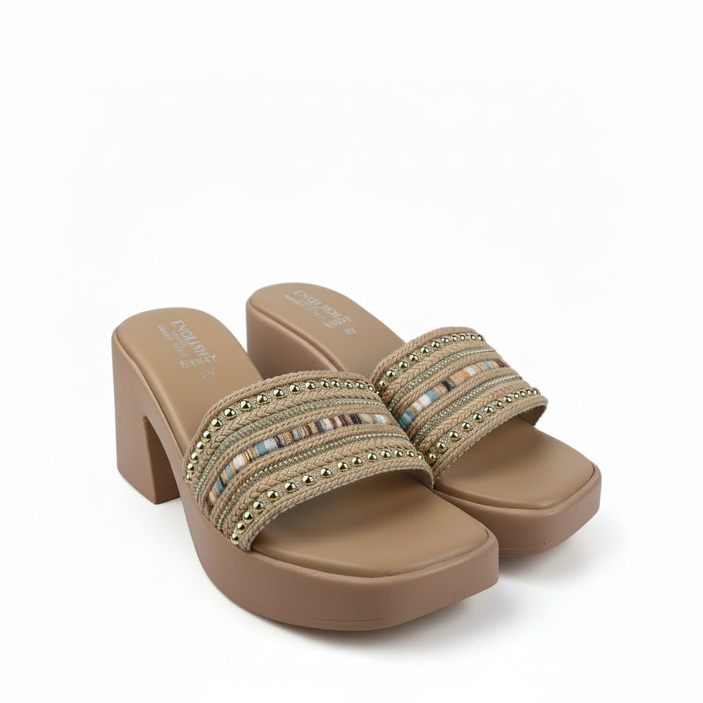 A pair of women's platform mule sandals in tan, featuring a block heel and double straps embellished with gold-tone studs and a central horizontal band of multicolored rhinestones, shown on a white studio background.