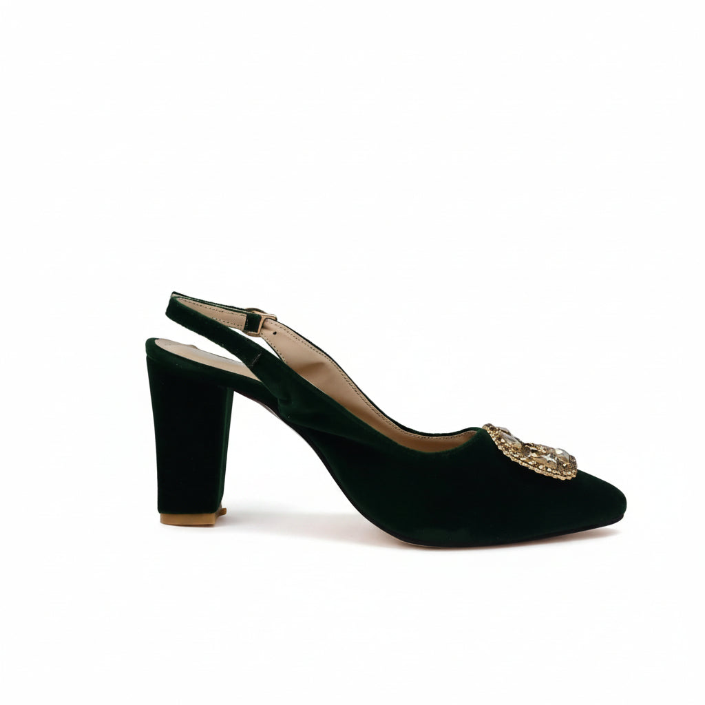 A single dark green velvet slingback high-heeled shoe with a pointed toe and a gold jeweled embellishment on the side, set against a plain white studio background.