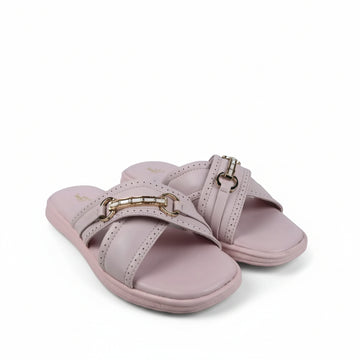 A pair of light pink slide sandals with double straps and gold-tone horsebit hardware, photographed on a white studio sweep with some visible creases and a black cable in the foreground.