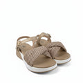 A pair of women's platform sandals with beige woven straps and a white sole, displayed on a white fabric backdrop.
