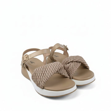 A pair of women's platform sandals with beige woven straps and a white sole, displayed on a white fabric backdrop.