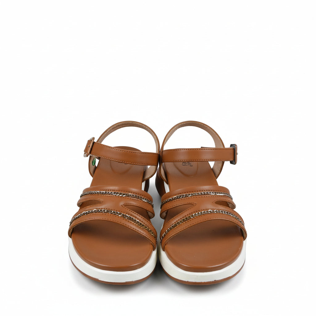 A pair of women's brown strappy sandals with rhinestone-embellished straps and white soles, shown next to a white shoebox on a white background.