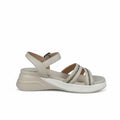 A single women's wedge sandal in a light cream or off-white color, featuring double straps with silver rhinestone embellishments and a low wedge heel, photographed against a wrinkled light gray background.