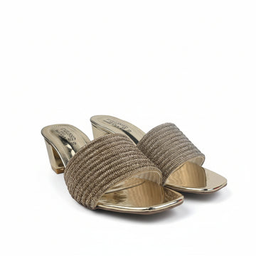A pair of women's heeled slide sandals with metallic gold metallic soles and straps, featuring a textured beige woven upper band, set against a white studio backdrop.