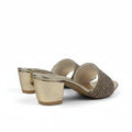 A pair of women's heeled mule sandals with metallic gold block heels and woven beige straps, shown on a white studio background.