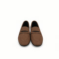 A pair of brown leather penny loafers with a curved cutout detail across the vamp, displayed next to an orange shoebox on a white background.
