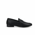 A single black leather penny loafer shown in profile against a light gray fabric backdrop.