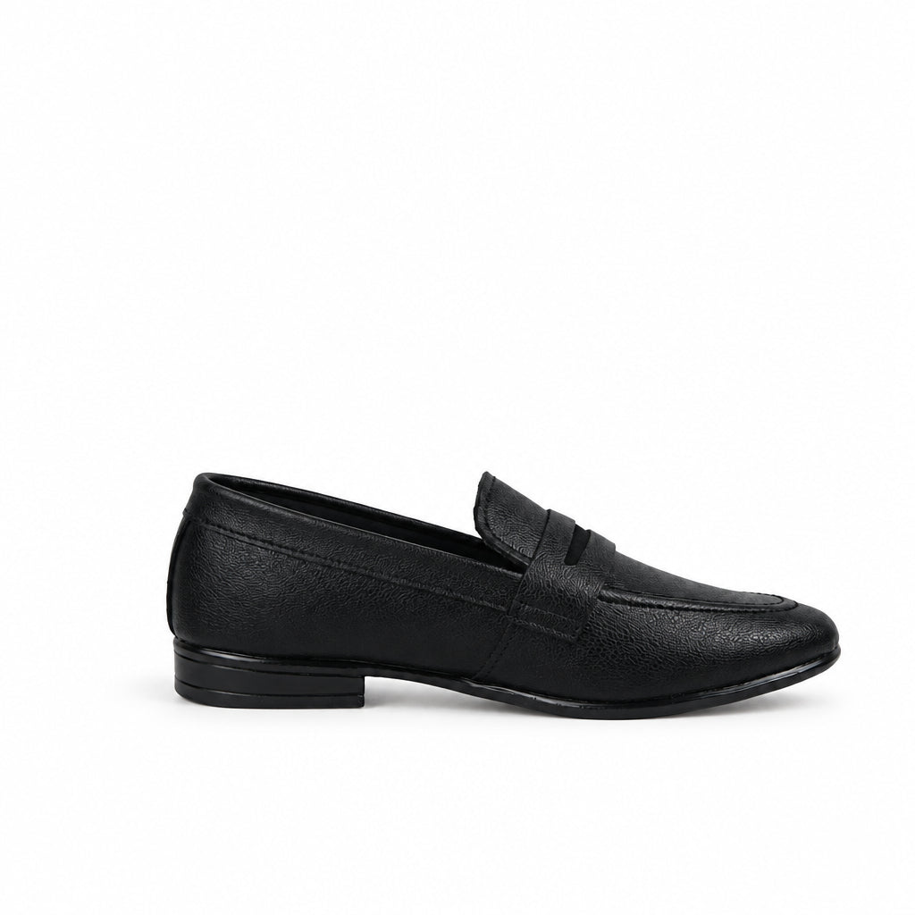 A single black leather penny loafer shown in profile against a light gray fabric backdrop.