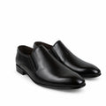 A pair of men's black leather slip-on dress shoes with elastic side panels, displayed on a white fabric backdrop.