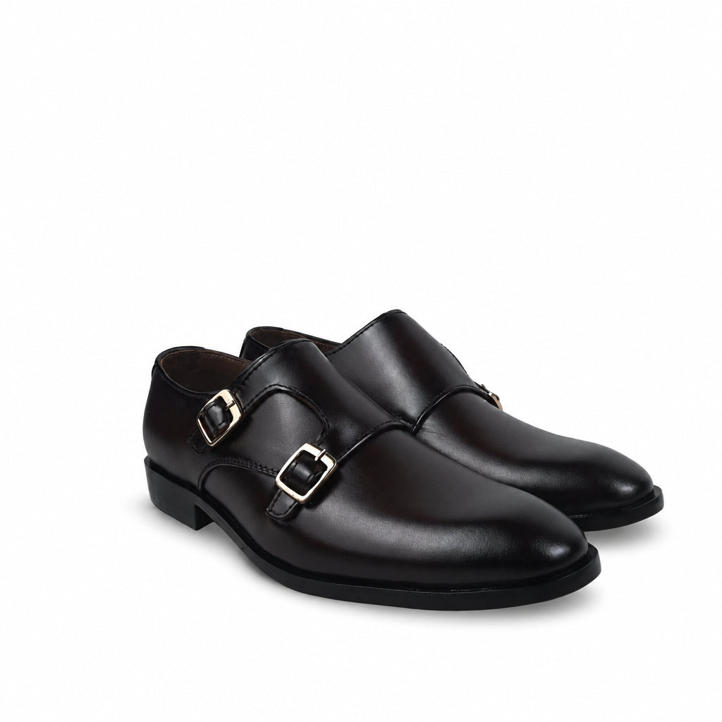 A pair of black leather double monk strap shoes with gold-tone buckle hardware, shown from a three-quarters angle on a clean white background.