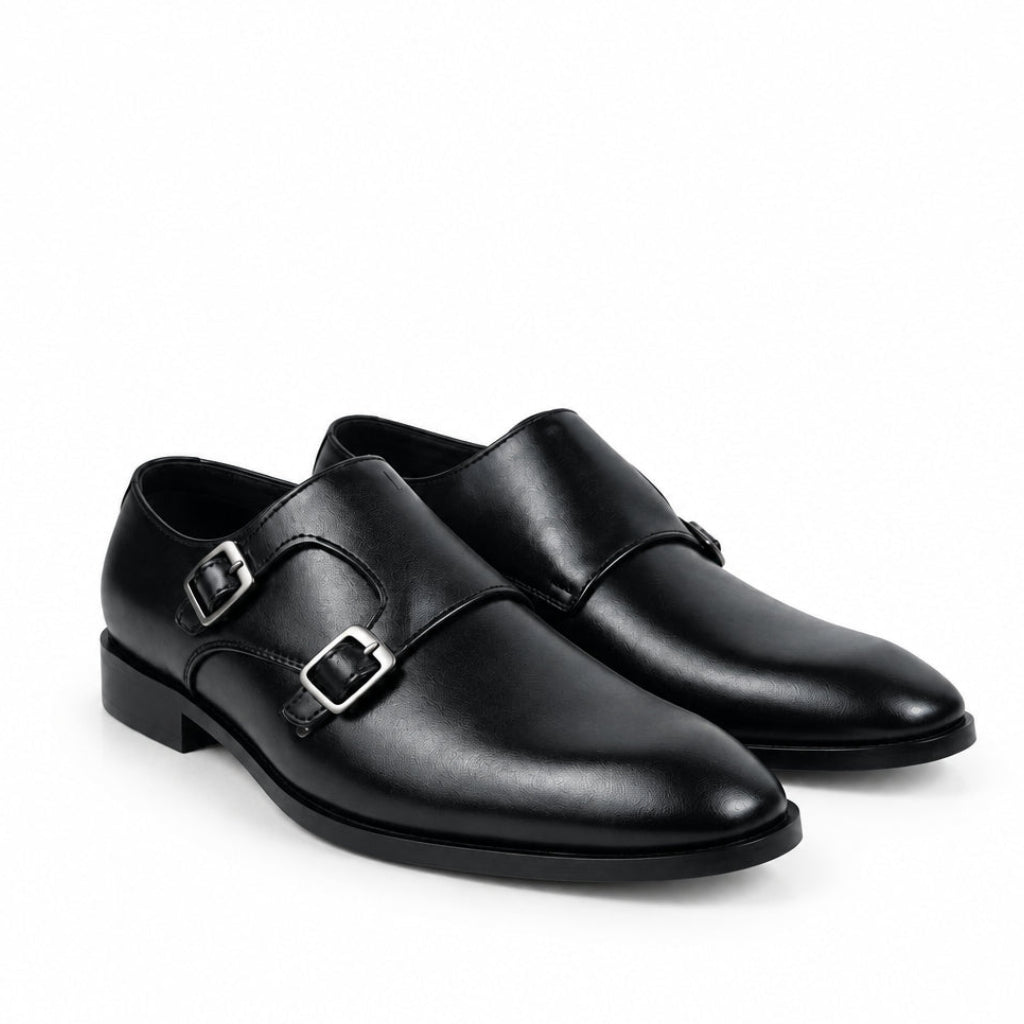 A pair of black leather double monk-style dress shoes with silver-tone buckle details, shown on a plain white background.