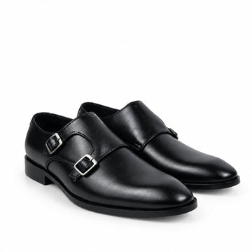 A pair of black leather double monk-style dress shoes with silver-tone buckle details, shown on a plain white background.