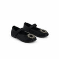 A pair of black Mary Jane style shoes with silver rhinestone embellishments on the toes, photographed on a white studio backdrop.