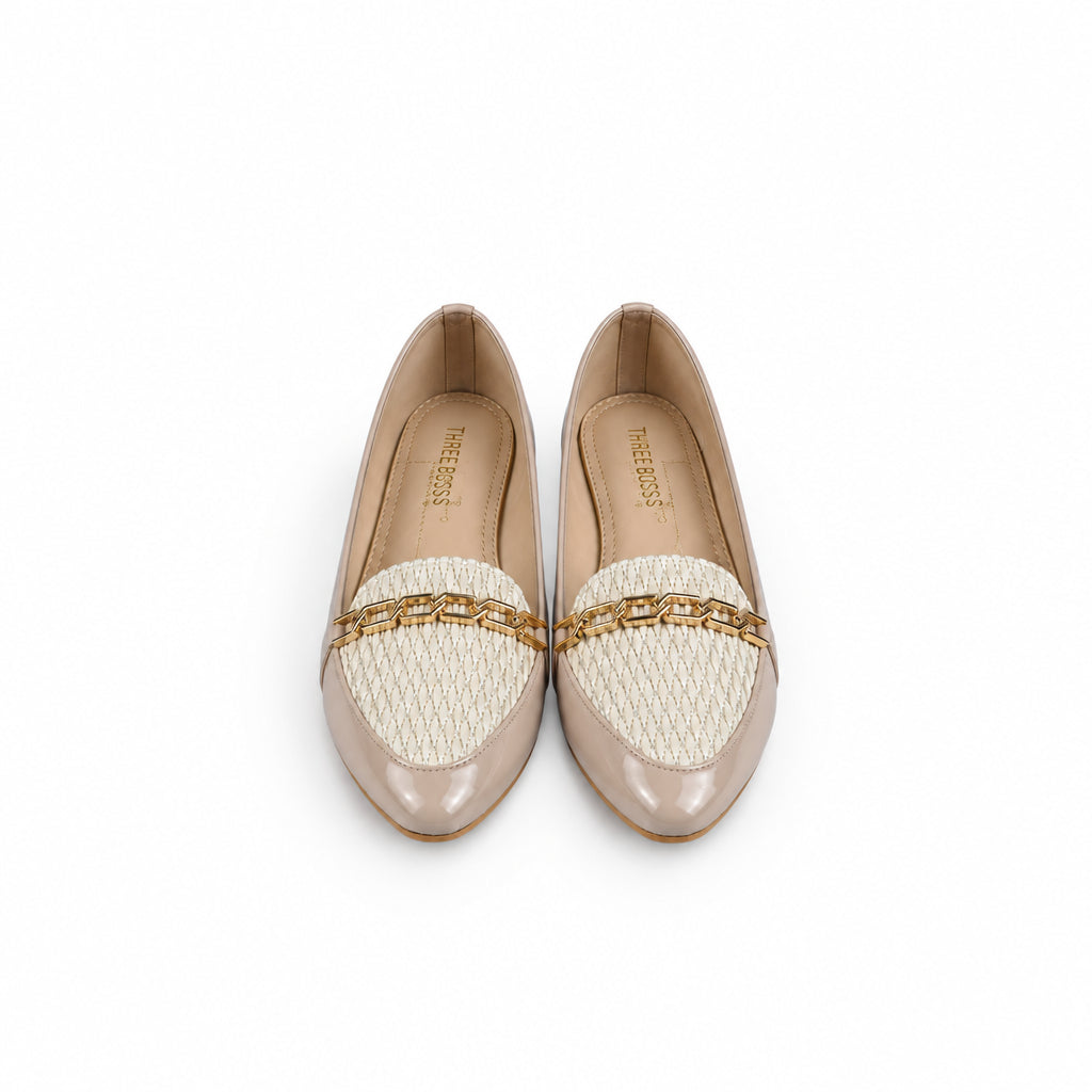 A pair of beige patent leather loafers with cream woven inserts and a gold chain detail across the vamp, photographed on a light gray surface.