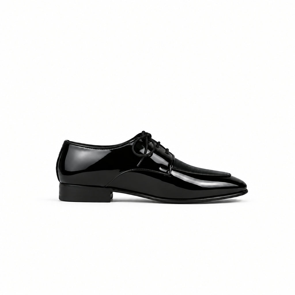 Black slip-on shoe with white sole on a light gray background