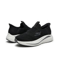 A pair of Skechers slip-on sneakers in black with a white and black sole, shown against a plain white background.