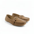 A pair of tan faux-leather moccasin loafers with a small silver buckle detail on the strap, shown on a plain white background.
