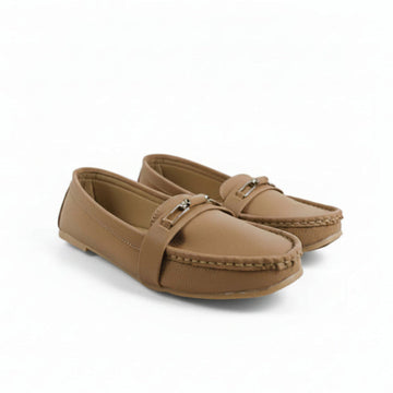A pair of tan faux-leather moccasin loafers with a small silver buckle detail on the strap, shown on a plain white background.