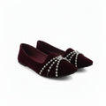 A pair of deep burgundy velvet flat shoes with silver beaded chains draped across the toe area, shown on a plain white background.
