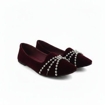 A pair of deep burgundy velvet flat shoes with silver beaded chains draped across the toe area, shown on a plain white background.