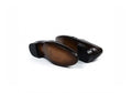A pair of dark brown  loafers shown from the sole side, displaying a polished finish and a subtle embossed logo, set against a plain white background.